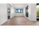 Bright living room featuring wood floors, a wall of windows, and a modern air conditioning system at 1601 Park Ave # 307, Denver, CO 80218