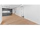 Open-concept living space with modern kitchen featuring stainless steel appliances and hardwood floors at 1601 Park Ave # 307, Denver, CO 80218