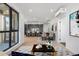 Open-concept living and dining area with hardwood floors, large windows, and modern decor at 1601 Park Ave # 307, Denver, CO 80218