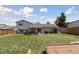 Backyard features a well-maintained lawn, a patio, and a shed, offering a serene outdoor space at 9683 Josephine Pl, Thornton, CO 80229
