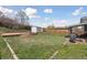 Expansive backyard featuring a fire pit, sheds and green lawn, perfect for outdoor activities and entertaining at 9683 Josephine Pl, Thornton, CO 80229
