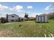 Spacious backyard with a shed, patio, and lawn, offering plenty of room for outdoor enjoyment at 9683 Josephine Pl, Thornton, CO 80229