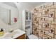Bathroom featuring a white sink and toilet with a cabinet above the toilet at 9683 Josephine Pl, Thornton, CO 80229
