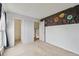 Empty bedroom featuring two doors and a large galaxy mural accent wall at 9683 Josephine Pl, Thornton, CO 80229