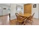 Dining room featuring wood flooring, a wooden table with chairs and extra wood cabinetry at 9683 Josephine Pl, Thornton, CO 80229