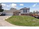 Charming split-level home featuring a well-manicured lawn, brick accents, and a spacious two-car garage at 9683 Josephine Pl, Thornton, CO 80229