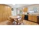 Eat-in kitchen features wood cabinets, black appliances and sliding doors to yard at 9683 Josephine Pl, Thornton, CO 80229