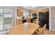 The eat-in kitchen has black appliances, wood cabinets and a door to the backyard at 9683 Josephine Pl, Thornton, CO 80229