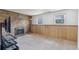 Spacious carpeted living room with wood walls, brick fireplace and large windows for natural light at 9683 Josephine Pl, Thornton, CO 80229