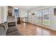 Inviting living room featuring hardwood floors, large windows, and an open staircase at 9683 Josephine Pl, Thornton, CO 80229