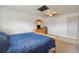 View of main bedroom featuring wood furniture, blue quilt, carpet and skylight with fan and lighting at 9683 Josephine Pl, Thornton, CO 80229