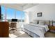 Bright bedroom with city views features a workspace and comfortable bed at 891 14Th St # 3415, Denver, CO 80202