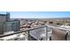 Balcony view of the cityscape showing multiple buildings and mountains in the distance on a clear sunny day at 891 14Th St # 3415, Denver, CO 80202
