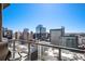 Balcony view showing downtown buildings and mountains in the distance, with a bright blue sky on a sunny day at 891 14Th St # 3415, Denver, CO 80202