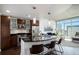 Stylish kitchen featuring stainless steel appliances, dark wood cabinets, and an island with barstool seating at 891 14Th St # 3415, Denver, CO 80202