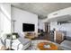 Open concept living area with hardwood floors, a modern TV, and a partial view of the kitchen at 891 14Th St # 3415, Denver, CO 80202