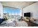 Bright living room featuring floor-to-ceiling windows with city views, modern furniture, and hardwood floors at 891 14Th St # 3415, Denver, CO 80202