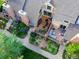 Stunning aerial view showcasing a well-maintained property with lush gardens, decks, and outdoor living spaces at 11894 Elk Head Range Rd, Littleton, CO 80127