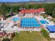 This is an aerial view of a community pool with lap lanes and recreation area, along with the clubhouse and tennis courts at 11894 Elk Head Range Rd, Littleton, CO 80127