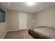 Cozy bedroom featuring neutral walls, carpet, and a closet with an accentuating dark bedframe at 11894 Elk Head Range Rd, Littleton, CO 80127
