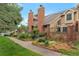 Attractive townhouse featuring well-maintained landscaping, a brick facade and a inviting entryway at 11894 Elk Head Range Rd, Littleton, CO 80127