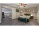 Spacious bedroom featuring modern flooring, contemporary decor, and access to a loft area at 11894 Elk Head Range Rd, Littleton, CO 80127