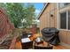 Private outdoor patio with wood floor and grill area, perfect for entertaining at 11894 Elk Head Range Rd, Littleton, CO 80127