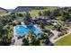 Aerial view of community swimming pool and clubhouse, with pools for swimming and playing at 11894 Elk Head Range Rd, Littleton, CO 80127