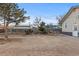 Spacious backyard with mature trees, garden beds and a wooden fence, offering privacy at 3912 S Acoma St, Englewood, CO 80110