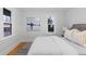 Light-filled bedroom with neutral decor, modern art, and plush bedding at 3912 S Acoma St, Englewood, CO 80110