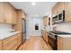 Charming kitchen featuring stainless steel appliances, stone countertops, and ample storage at 3912 S Acoma St, Englewood, CO 80110