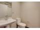 Clean half bathroom featuring a pedestal sink and modern toilet at 410 Acoma St # 212, Denver, CO 80204