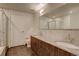 Bathroom featuring double sinks, granite countertops, and tile flooring at 410 Acoma St # 212, Denver, CO 80204