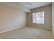 Minimalist bedroom with neutral carpet, a ceiling fan, and a large window for natural light at 410 Acoma St # 212, Denver, CO 80204