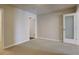 Spacious carpeted bedroom with neutral walls, white trim, and multiple doorways at 410 Acoma St # 212, Denver, CO 80204