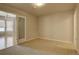 Well-lit carpeted room with neutral walls, open door, and modern lighting at 410 Acoma St # 212, Denver, CO 80204