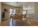 Bright dining area with hardwood floors and a set table, seamlessly blending into the inviting living space at 410 Acoma St # 212, Denver, CO 80204