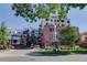 Beautiful multi-story building with brick facade and lush green landscaping at 410 Acoma St # 212, Denver, CO 80204