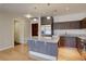 Bright kitchen boasts a granite island with pendant lights, sleek cabinets and stainless steel appliances at 410 Acoma St # 212, Denver, CO 80204