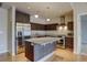 Modern kitchen featuring a stainless steel refrigerator, granite counters, and an island with seating at 410 Acoma St # 212, Denver, CO 80204