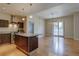 Open-concept kitchen and dining area with stainless steel appliances and a sliding glass door to a balcony at 410 Acoma St # 212, Denver, CO 80204