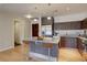 Bright kitchen boasts a granite island with pendant lights, sleek cabinets and stainless steel appliances at 410 Acoma St # 212, Denver, CO 80204