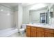 Bright bathroom features a double vanity and shower-tub combo at 19421 E Milan Cir, Aurora, CO 80013