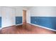 This bedroom features a double closet and hardwood floors at 19421 E Milan Cir, Aurora, CO 80013