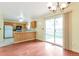 Bright kitchen with laminate wood floors and a sliding glass door to the backyard at 19421 E Milan Cir, Aurora, CO 80013