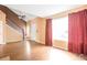 Bright living room featuring wood floors, a staircase, and large windows at 19421 E Milan Cir, Aurora, CO 80013