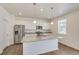 A modern kitchen featuring stainless steel appliances, granite countertops, white cabinets, and pendant lighting at 298 Chardon Ave, Brighton, CO 80601