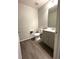 Powder room featuring a modern sink, toilet, fixtures and stylish flooring at 10117 Granby St, Commerce City, CO 80022