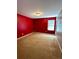 Bedroom featuring red walls, carpeting, and natural light at 10117 Granby St, Commerce City, CO 80022