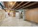 Unfinished basement with exposed brick, open ceiling, and concrete floor at 265 S Pennsylvania St, Denver, CO 80209